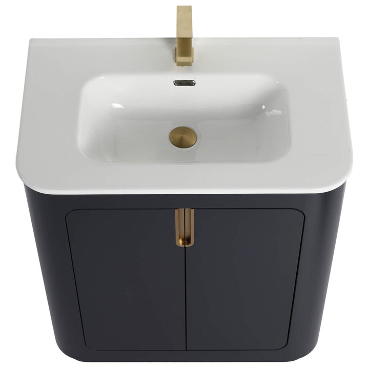 The Shireplace 30 Inch Bathroom Vanity With Sink features a modern design with a white rectangular basin, brass-colored faucet, and dark gray cabinet. Rounded edges and double doors highlighted by sleek brass handles complete the elegant look.