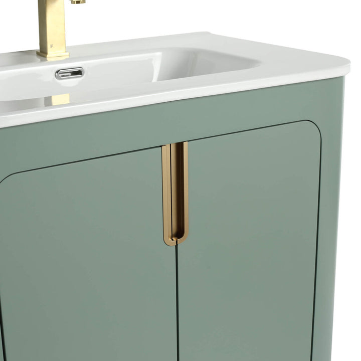 Explore the Shireplace 30 Inch Bathroom Vanity, featuring a sleek design with a light green cabinet and gold handles. This contemporary piece boasts clean lines, a white sink, and an integrated faucet for modern elegance.