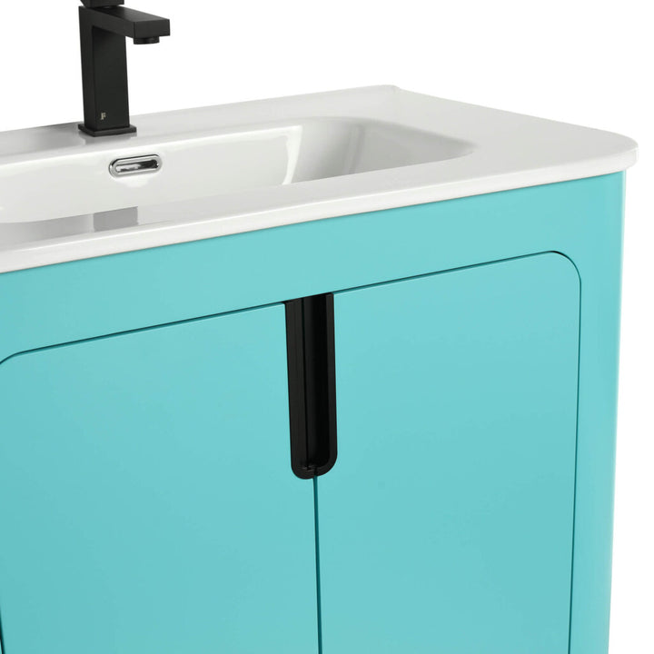 A close-up of the Shireplace 30 Inch Bathroom Vanity With Sink highlights its turquoise design, white countertop with integrated sink, two-door cabinet with vertical black handles, and a sleek matte black faucet for a modern look.