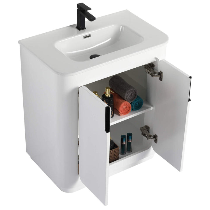 The Shireplace 30 Inch Bathroom Vanity With Sink showcases a modern design with a black faucet and rectangular sink. Double doors reveal two shelves holding rolled towels and toiletries, bringing organized elegance to any bathroom.