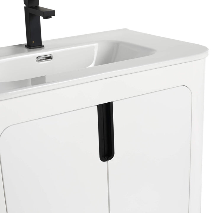 The Shireplace 30 Inch Bathroom Vanity With Sink showcases a modern look with a rectangular sink, sleek black faucet, glossy white cabinet doors, and vertical black stripes for a minimalist aesthetic.