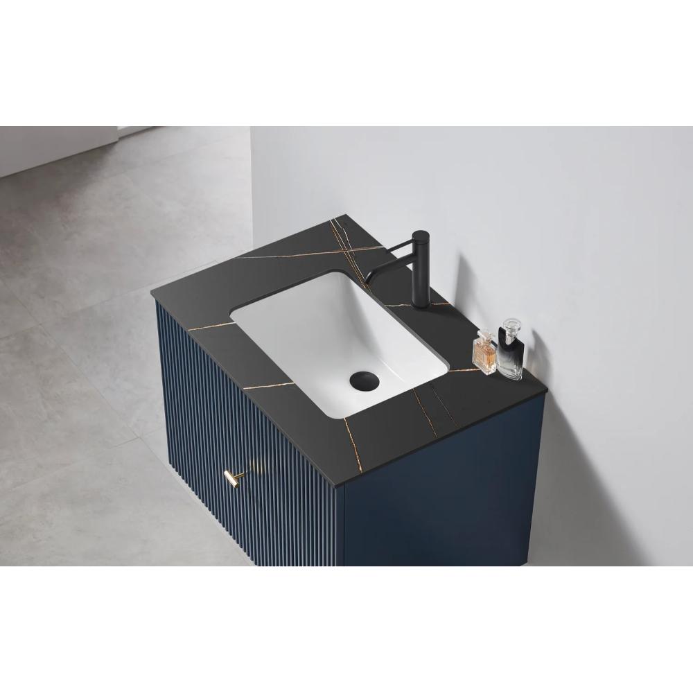 The Barcelona 30 Inch Wall Mount Bathroom Vanity showcases a black countertop with gold streaks, a white rectangular sink, and black faucet, all set against a light wall and floor.