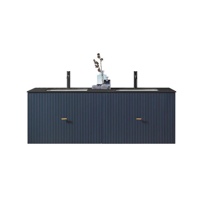 A modern Barcelona 60 Inch Wall Mount Double Bathroom Vanity with a dark blue finish, vertical grooves, black faucets, two gold handles, and a black countertop. A decorative vase with flowers is placed between the sinks.
