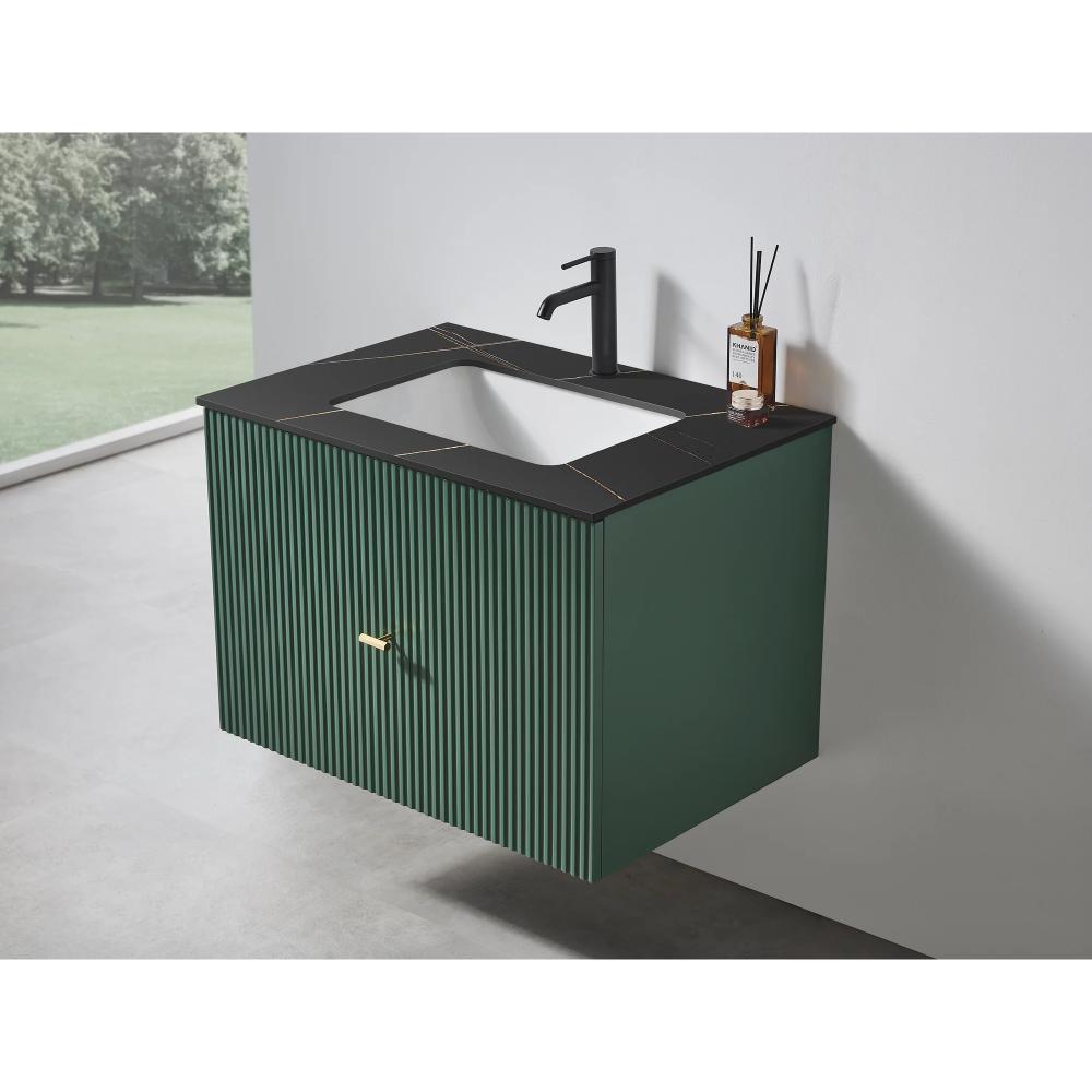 The Barcelona 30 Inch Wall Mount Bathroom Vanity showcases a dark green ribbed front, black integrated sink and countertop, matte black faucet, and gold handle. A diffuser rests atop the vanity, while a window provides a view of greenery.