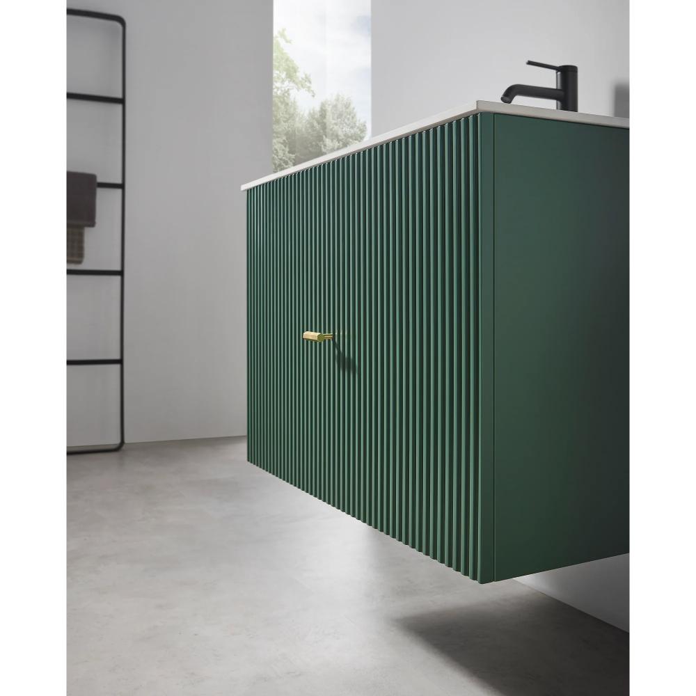 A modern bathroom features the Barcelona 30 Inch Wall Mount Bathroom Vanity in green with vertical grooves, a white countertop, and a black faucet. The minimalist space includes a window and a black towel rack in the background.