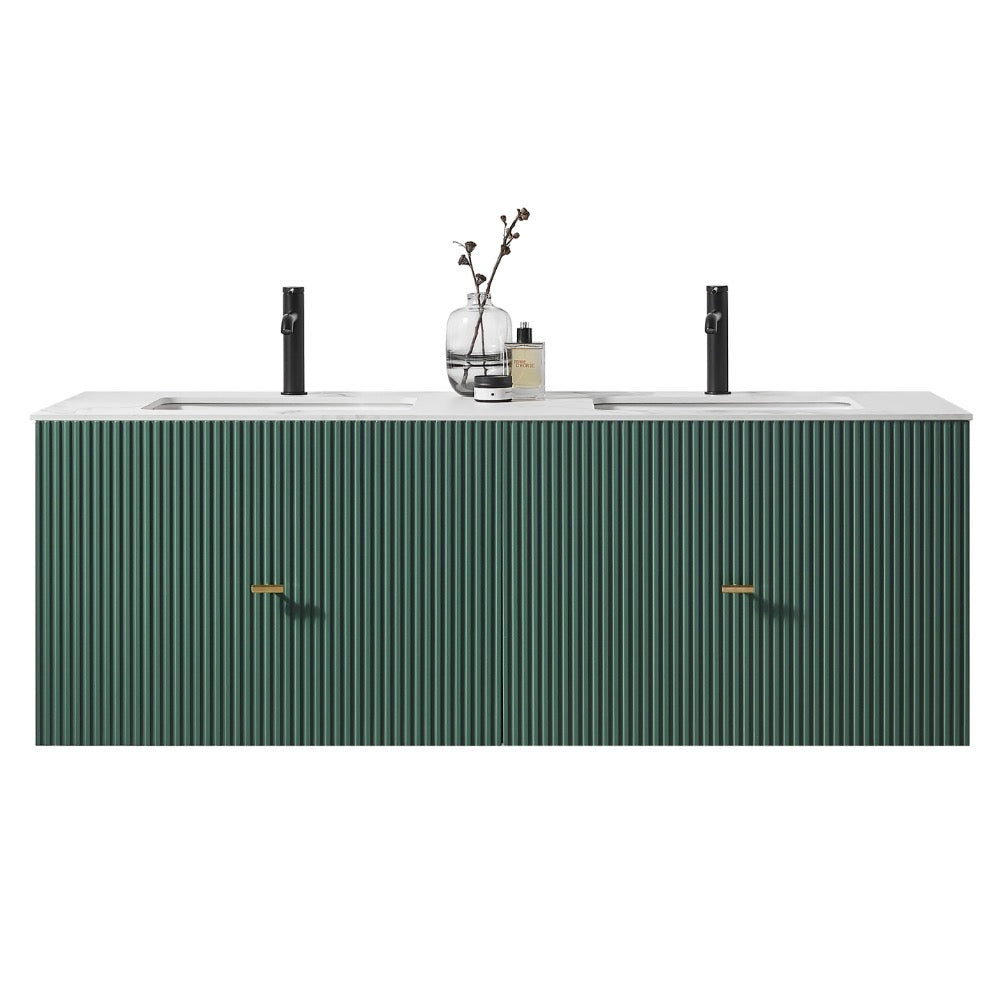 A modern Barcelona 60 Inch Wall Mount Double Bathroom Vanity With Top, featuring a ribbed green front, gold handles, and a white countertop. Two black faucets, a glass vase with branches, and a bottle sit on top.