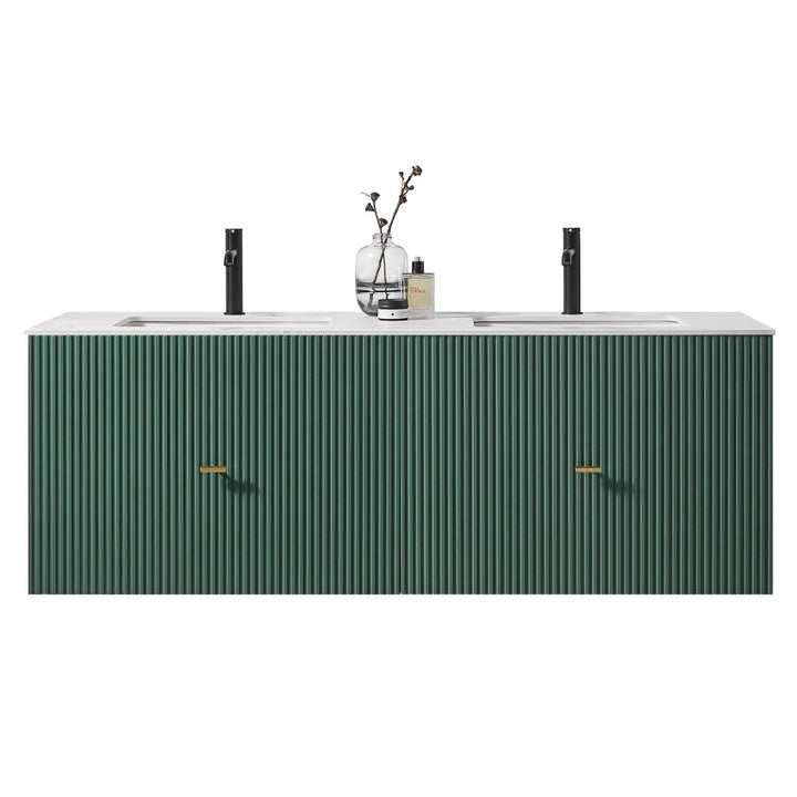 A modern Barcelona 60 Inch Wall Mount Double Bathroom Vanity With Top, featuring a ribbed green front, gold handles, and a white countertop. Two black faucets, a glass vase with branches, and a bottle sit on top.