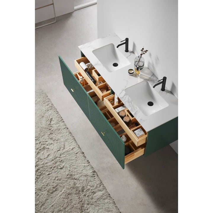 A modern bathroom features a Barcelona 60 Inch Wall Mount Double Bathroom Vanity With Top. The green drawers are open, displaying organized toiletries and accessories. A textured rug lies on the light gray floor.