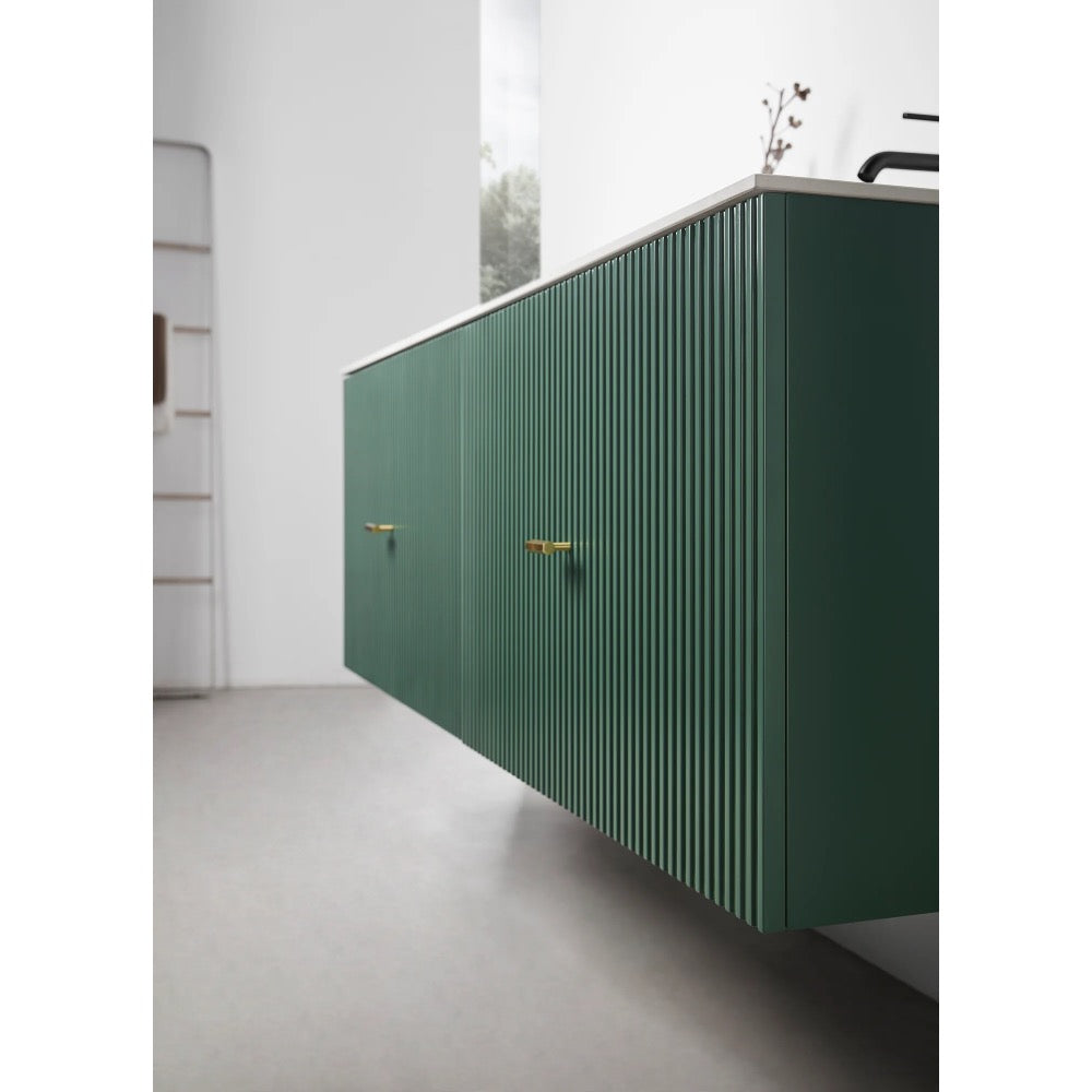 A modern kitchen with green, wall-mounted cabinets featuring vertical grooves and gold handles, inspired by the sleek style of the Barcelona 60 Inch Wall Mount Double Bathroom Vanity With Top, set against a light floor and minimal decor.