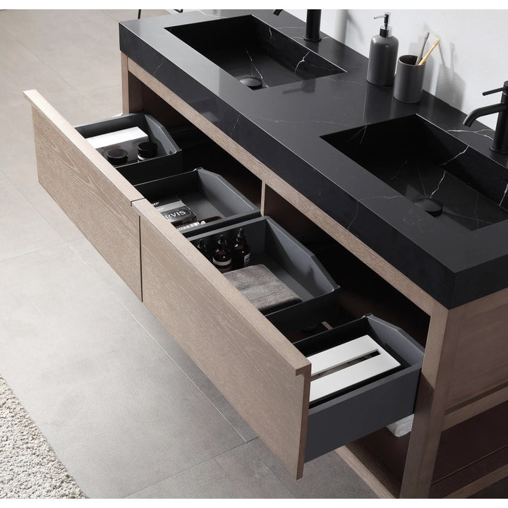 The Bibury 60 Inch Double Bathroom Vanity with Top features a modern design, black countertop, and two sinks; open wooden drawers reveal organized compartments for toiletries, towels, and bathroom essentials.
