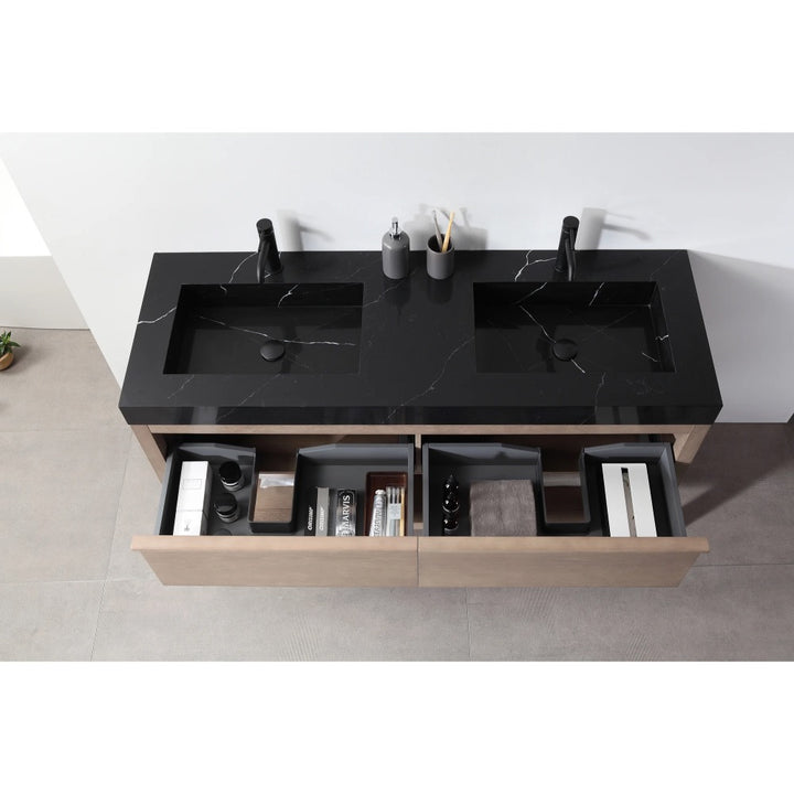The Bibury 60 Inch Double Bathroom Vanity with Top showcases a modern black double sink countertop, two black faucets, and open wooden drawers with toiletries and accessories, all elegantly viewed from above.