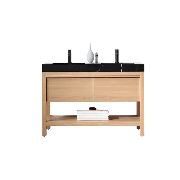 The Bibury 48 Inch Double Bathroom Vanity with Top boasts a modern wooden design, black countertop, two sinks and faucets, a white vase, soap dispenser, and neatly folded white towels on the bottom shelf.