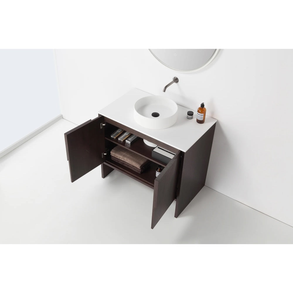 The Celle 36 Inch Bathroom Vanity With Vessel Sink has dark wood cabinets with shelves inside, a white countertop with a round vessel sink and faucet, and is paired with a round mirror above.