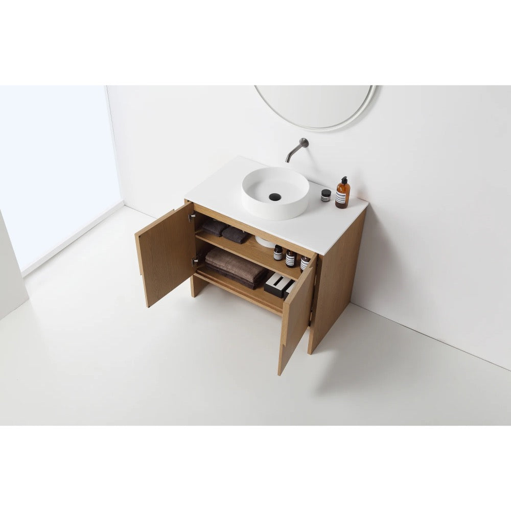 The Celle 36 Inch Bathroom Vanity With Vessel Sink features a white countertop, round basin, and light wood cabinet with double doors for organized storage. A round mirror is mounted above the sink.