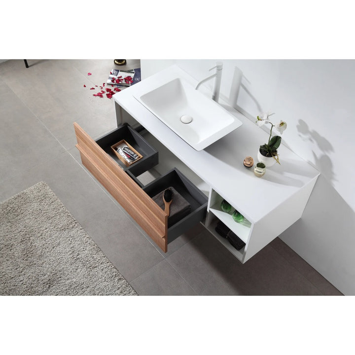 The Goreme 48 Inch Wall Mount Bathroom Vanity With Vessel Sink features open wooden and black drawers, shelves with bottles, and rose petals scattered on the floor nearby.