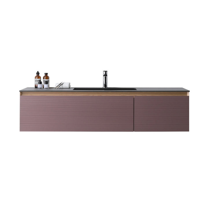 The Oslo 60 Inch Wall Mount Single Bathroom Vanity features a ribbed mauve front, black countertop, and built-in sink. Two bottles and a small towel on the left side add style and function to your modern bathroom.