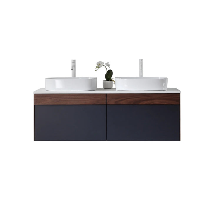 The Ronda 55 Inch Wall Mount Vanity with Double Vessel Sinks boasts a modern design, dark wood and navy cabinet, two white vessel sinks, and a small potted orchid set between them.
