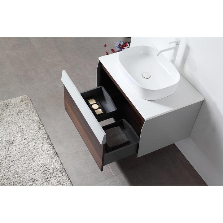 A Ronda 30 Inch Wall Mount Bathroom Vanity with a white vessel sink and open drawers displaying toiletries and towels sits above a gray tiled floor next to a white textured rug.