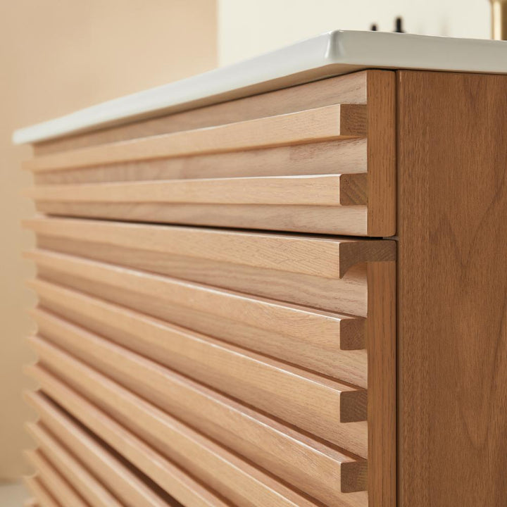 A close-up view of a Linea 36 Inch Wall Mounted Bathroom Vanity, featuring a wooden cabinet with horizontal slatted panels and a white countertop, highlighting the texture and grain of the wood.