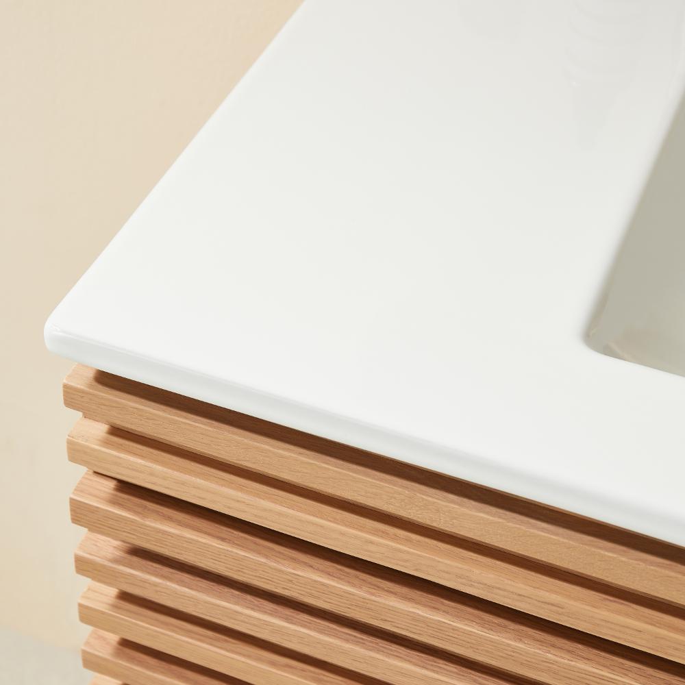 Close-up of the Linea 36 Inch Wall Mounted Bathroom Vanity, featuring a modern design with a white countertop and a wooden base with horizontal slats.
