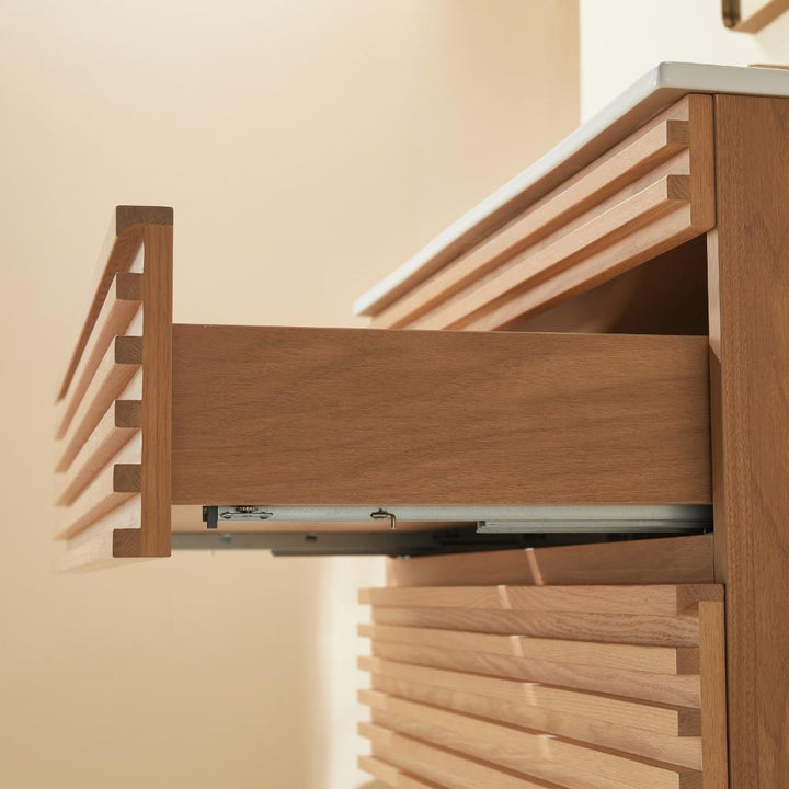 A close-up of the Linea 36 Inch Wall Mounted Bathroom Vanity with a partially open drawer reveals smooth wood grain and modern horizontal grooves, while warm lighting highlights its texture and craftsmanship.