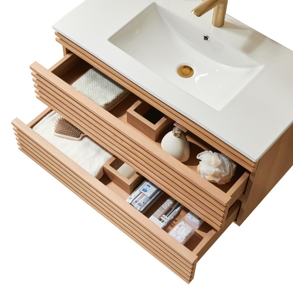 Overhead view of a modern Linea 36 Inch Wall Mounted Bathroom Vanity with two open drawers, neatly organized with towels, soap, toiletries, and a white sink featuring a gold faucet.