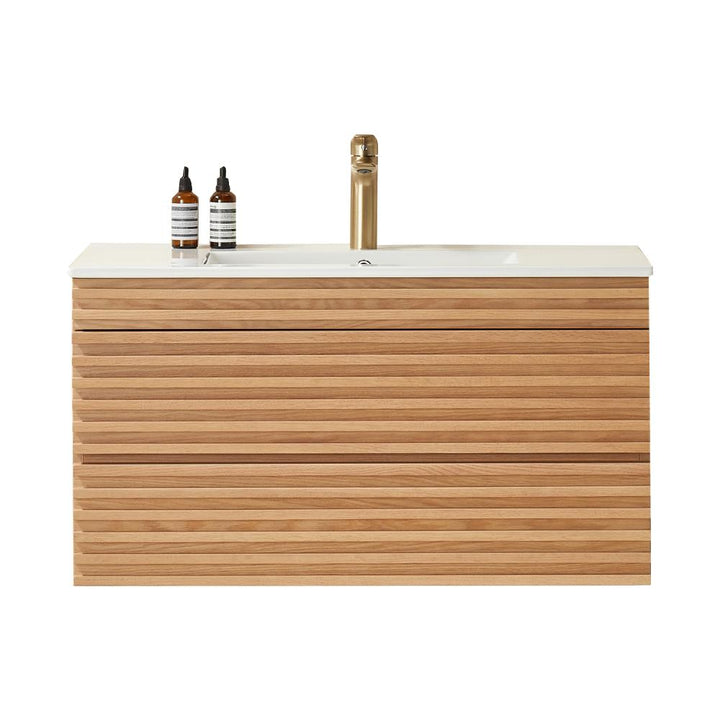 The Linea 36 Inch Wall Mounted Bathroom Vanity boasts a modern horizontal wood slat design, white countertop, gold faucet, and two brown-striped soap dispensers for a sleek, contemporary look.