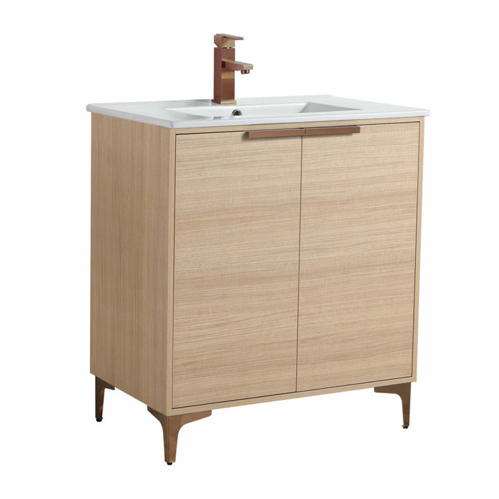 Introducing the Wilmington 30 Inch Bathroom Vanity With Sink, featuring a light wood finish, two cabinet doors, a white countertop, and completed with a bronze faucet and sleek bronze legs for an elegant blend of style and functionality.