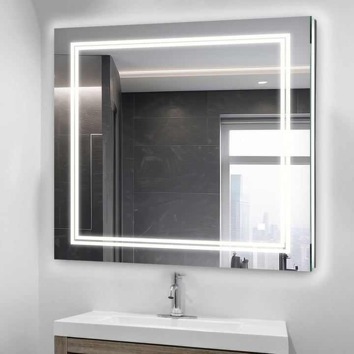 A modern bathroom features the Soho 30 Inch x 30 Inch LED Lighted Bathroom Mirror above a sink and wooden vanity, its edge-lit LEDs glowing as a window reflects a cityscape in the background.