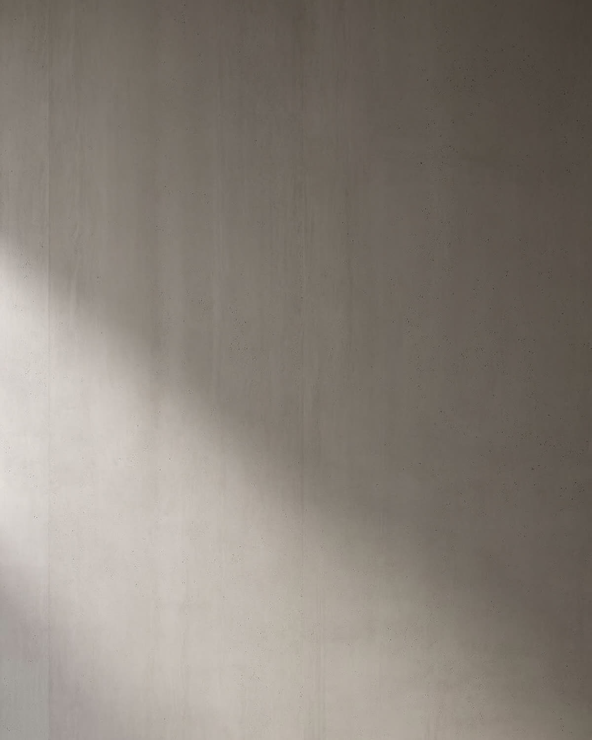 Matte grey-taupe ultracompact stone surface with fine mineral texture