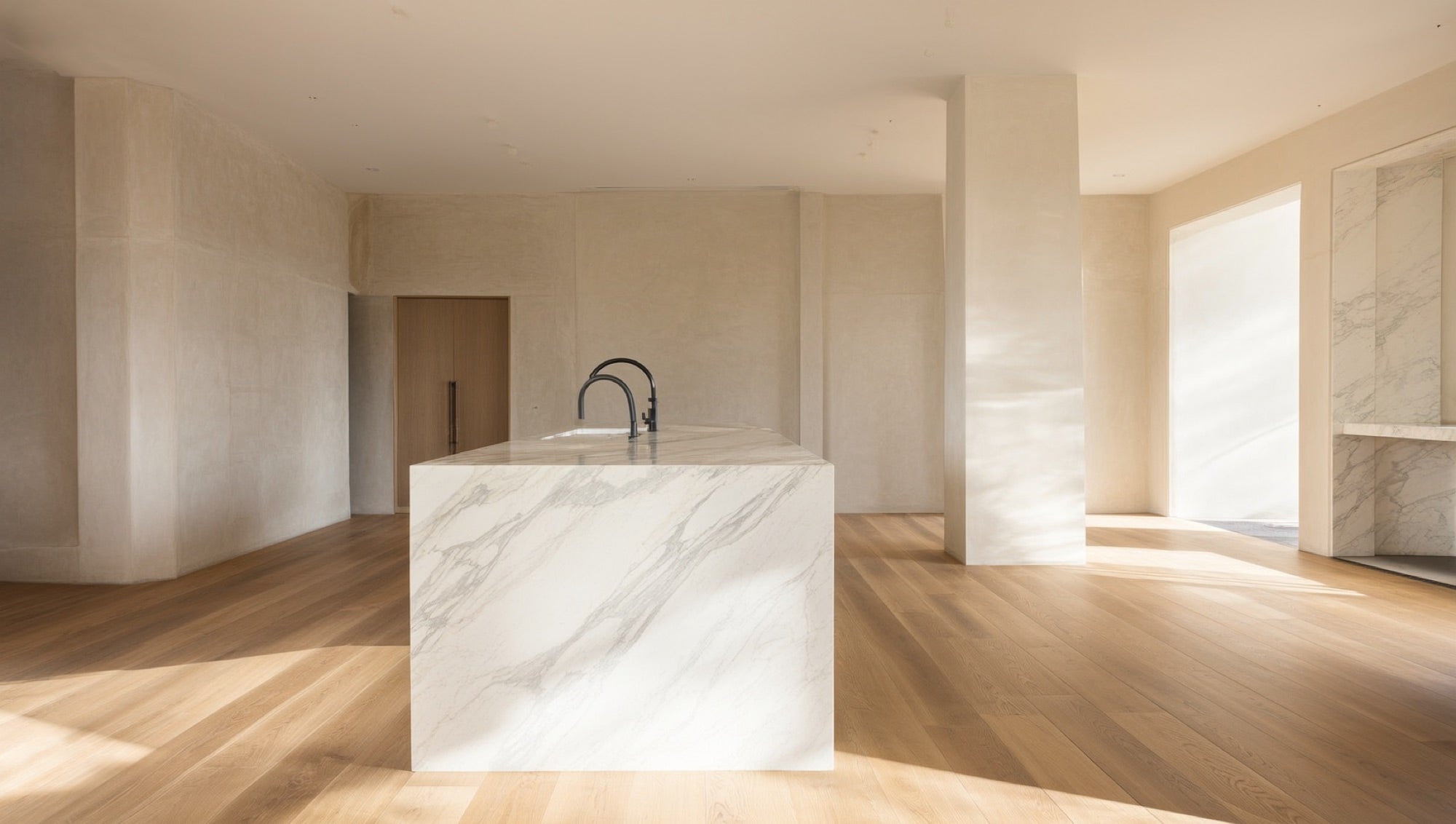 White marble-look quartz waterfall island with wood-look flooring