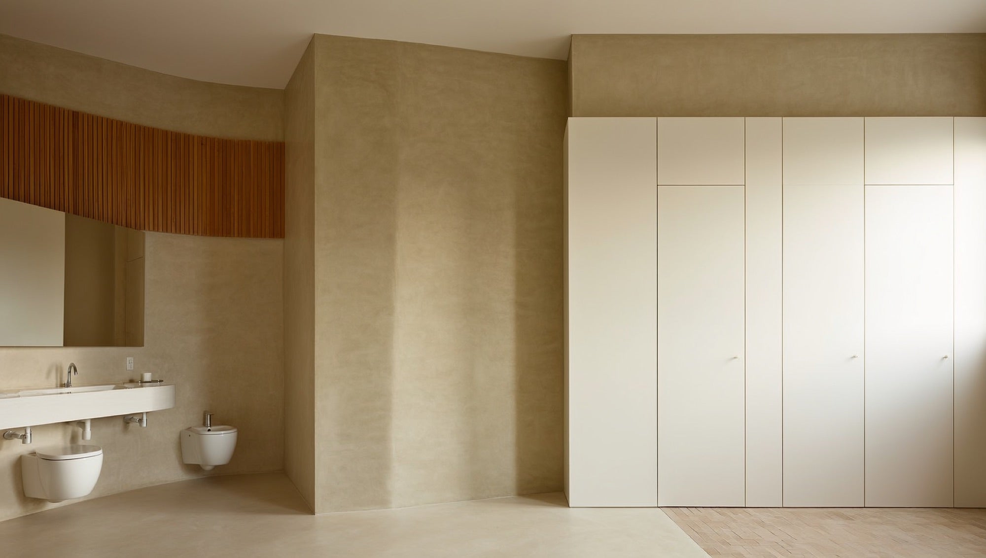 Wall-hung European basin and toilet with oak slat accent