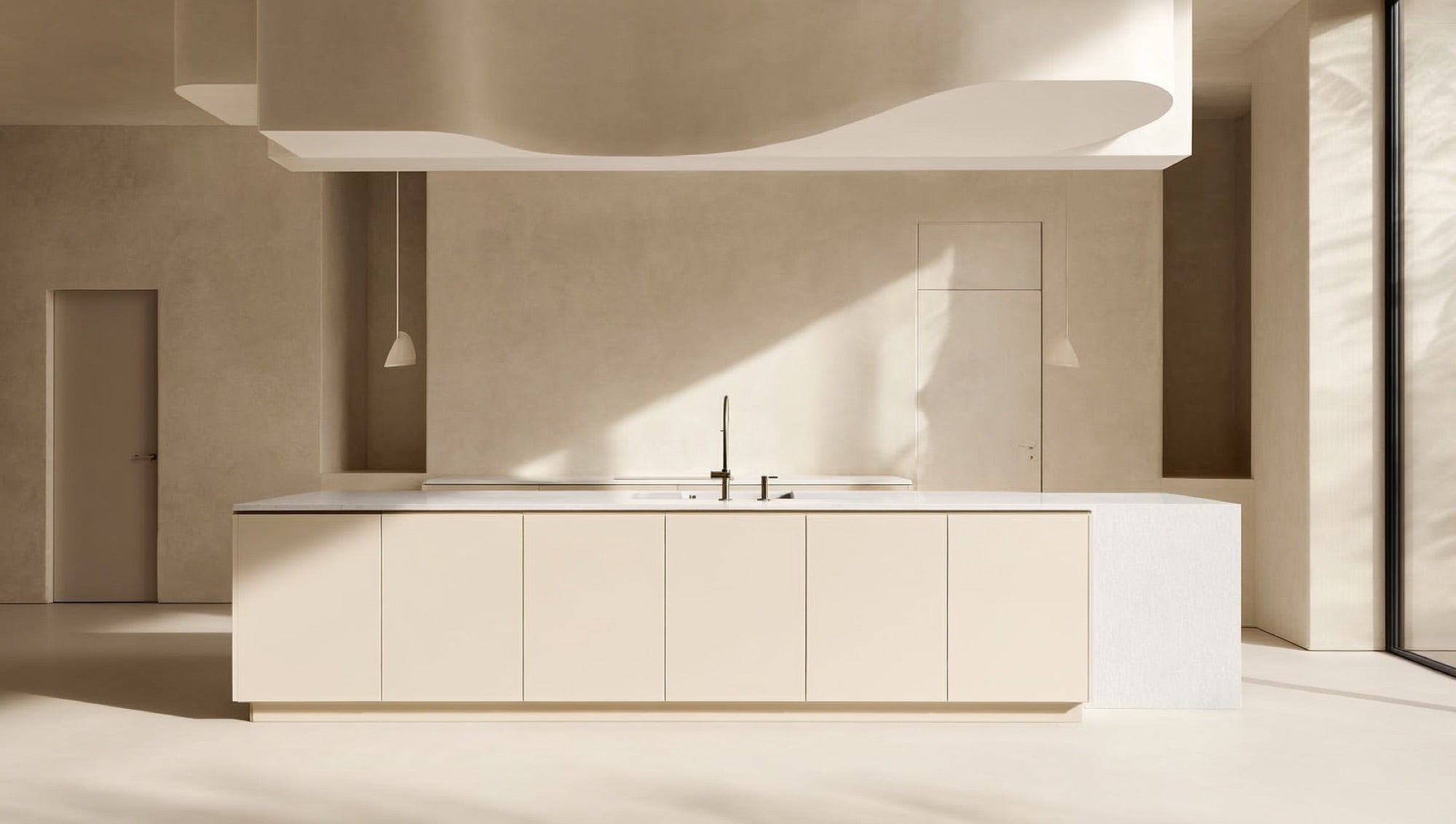 Minimal cream kitchen with a long cream island and white quartz countertop