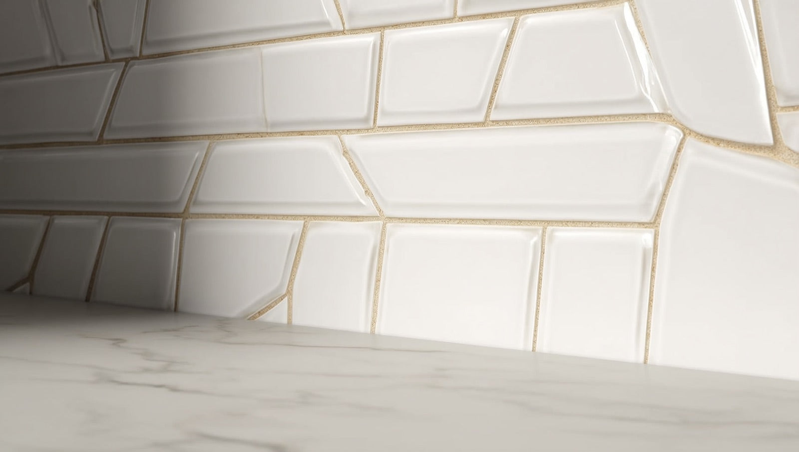 Close-up of beveled glossy white subway tile on a kitchen backsplash with warm grey grout lines catching side light.