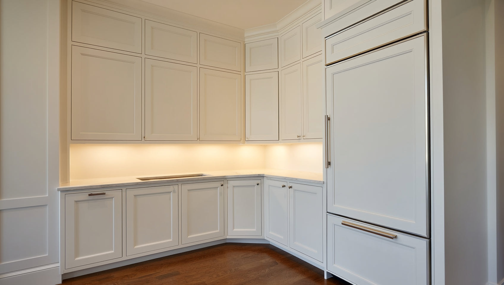 Custom-sized white Shaker kitchen cabinets running full height with filler-free runs in a renovated Babylon, NY kitchen &mdash; from ANVE Kitchen & Bath