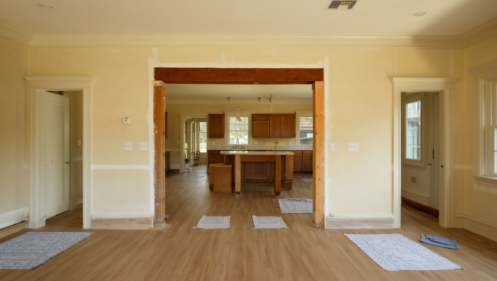 Classic American colonial-style home kitchen mid-renovation with an opened wall to the dining room
