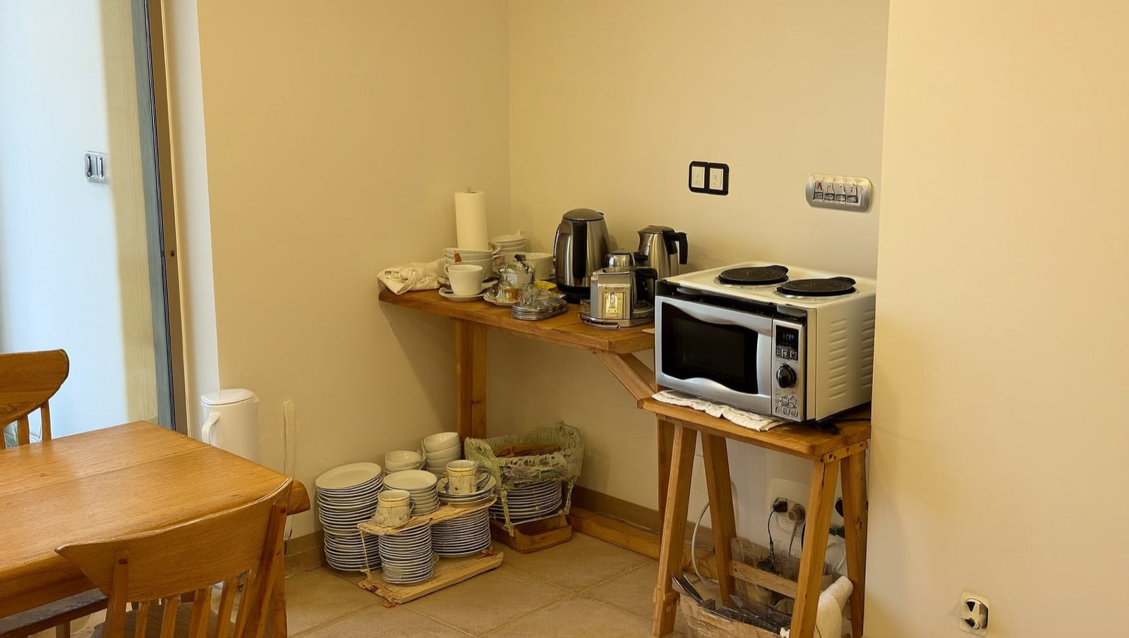 Temporary kitchen setup during a remodel: microwave, induction burner and coffee station on a folding table