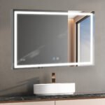 The Daytona 48 Inch x 36 Inch LED Lighted Bathroom Mirror above a marble countertop with a white vessel sink and bronze faucet features touch controls, a digital clock, and reflects a window showing the blue sky.