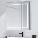 The Royale Plus 30 Inch x 36 Inch LED Lighted Mirror Medicine Cabinet is mounted above a white sink with a black faucet, set against a light-colored wall.