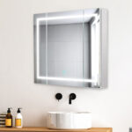 A modern bathroom features a round white sink, black faucet, and a Royale Plus 36 Inch x 30 Inch LED Lighted Mirror Medicine Cabinet above, reflecting tiled walls. Two soap dispensers sit on the wooden counter beside the sink.