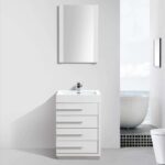 The Barcelona 24 inch Bathroom Vanity Set in Glossy White, featuring four drawers, a rectangular sink, and a silver faucet, sits below a wall-mounted mirror, with a white bathtub by a window overlooking the ocean in the background.