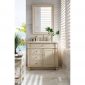 A bright bathroom with a 36 inch bathroom vanity in light wood, marble countertop, potted plant, and mirror. Sunlight streams through white shutters, illuminating the space with a view of the pool and greenery outside.