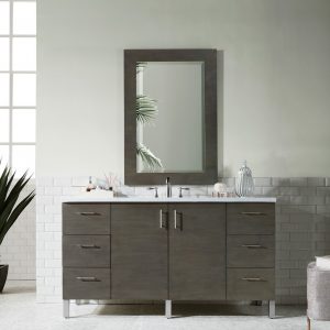 A modern bathroom showcases the Metropolitan 60 inch Single Bathroom Vanity in Silver Oak with six drawers and two cabinet doors. A rectangular mirror hangs above. The walls are half white-tiled, half pale green. A small plant sits on the left, and a cushioned stool is on the right.