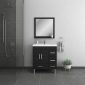 Modern bathroom with dark gray tiles, a wall-mounted shower on the left, a black vanity with a white sink and mirror in the center, a hand towel on a ring, and a small potted plant on the right.