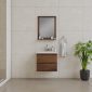 Minimalist bathroom with beige tiled walls, a wooden vanity with a white sink, a rectangular mirror, small toiletries, a towel on a ring, and a potted green plant on the floor.