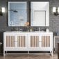 A modern bathroom features the Athens 72 Double Bathroom Vanity in Glossy White, enhanced by striped wood cabinet doors and topped with two square mirrors. The dark textured wall has two wall sconces, with natural light streaming from a right-side window. A towel hangs conveniently beside the sink.