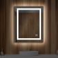 A modern bathroom showcases the Lyra 24 x 30 Inch LED Mirror on a wood-paneled wall. Beneath it, a round white sink with a silver faucet enhances the design. A small plant and container bring a natural touch to the countertop.