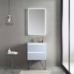 A minimalist bathroom features a sleek white Jena 24-inch Wall Mount Vanity with LED Lights and an illuminated mirror. A glass dispenser and towels rest on a round glass table, under a modern pendant light. A floor-to-ceiling window on the right enhances the clean, contemporary look with neutral tones.