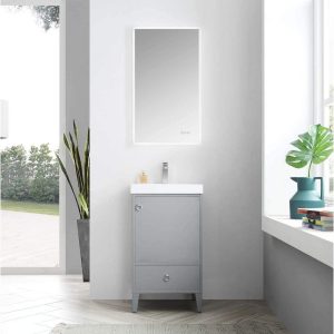 A modern bathroom is equipped with a Lyon 20 Bathroom Vanity with Acrylic Sink in Metal Gray, paired with an LED-lit rectangular mirror. A slender plant accents the vanity, while a window on the right highlights a large leaf plant in a blue vase, welcoming ample natural light into the space.
