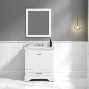 A modern bathroom highlights a Copenhagen 30-inch matte white vanity with a Carrara marble top and two-door cabinet. A large rectangular mirror is mounted above, set against gray and white wall paneling, with a geometric hanging light on the right. The floor features elegant white marble.